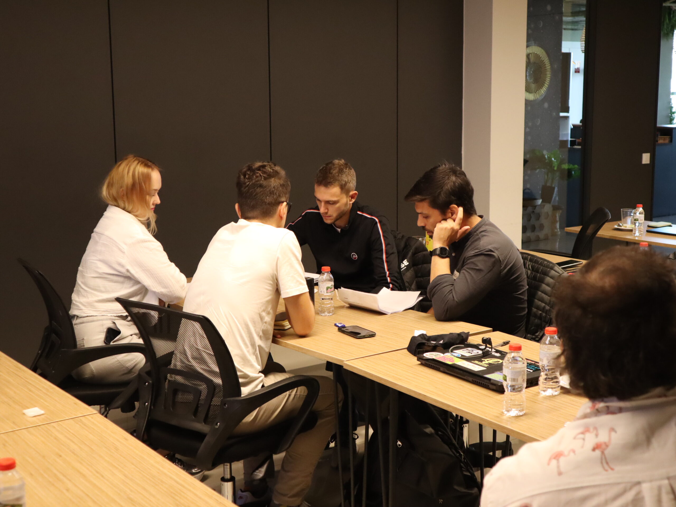Workshop participants discussing an athlete case around the table